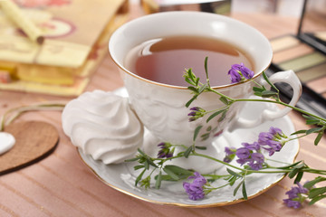cup of tea and meringue cookie