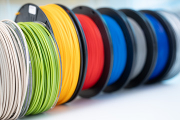 ABS and PLA filament next to 3D Printer. Plastic   coils - obrazy, fototapety, plakaty