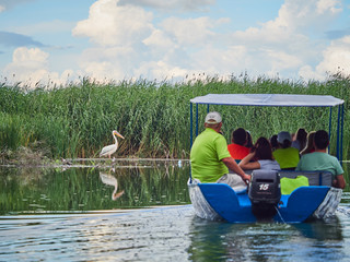 Tourists on a boat in the Danube Delta, Romania
