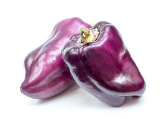 Organic purple bell peppers isolated on white background