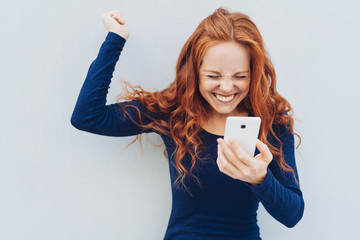 Young redhead celebrating good news