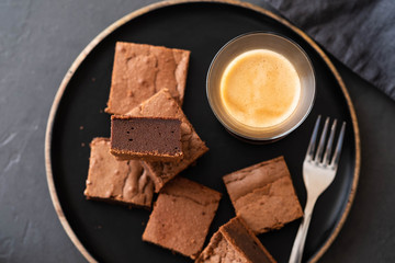 Double Chocolate Brownies. Homemade chocolate fudge brownies with chocolate chips and black background. Copy space.