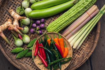 Thai raw ingredients vegetables for Thai food in a bamboo basket on the table