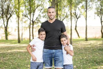 Fototapeta premium Young father posing with his children