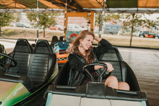 Excited woman riding bumper car