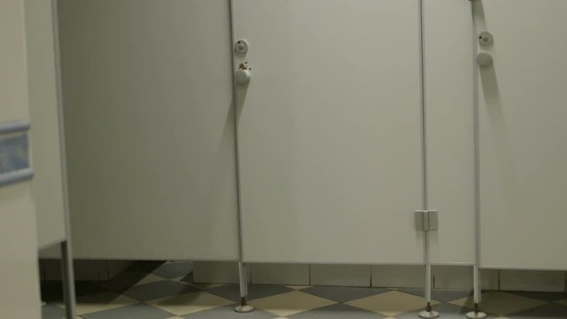 male man runs into the toilet cabin in public wc