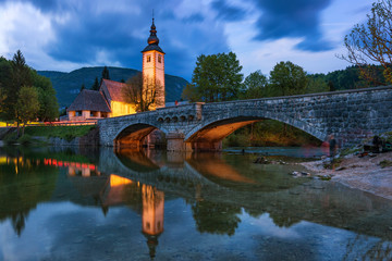 Church of Sv. John the Baptist and a bridge by the Bohinj lake in night, Slovenia. Church of St John the Baptist with bridge. Triglav National Park, Julian Alps, Slovenia, Europe