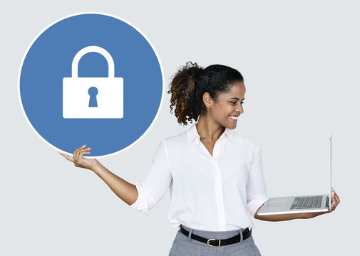 Woman holding a padlock and a laptop