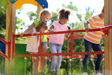 Cute little children having fun on playground outdoors