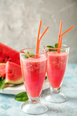 Glasses with fresh watermelon smoothie on light table