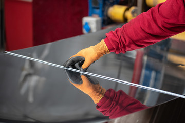 the hands of the worker measure the size of metal with a tape measure