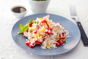Plate with tasty boiled rice and vegetables on white table, closeup