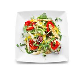 Plate with delicious chicken salad on white background