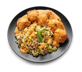 Plate with boiled rice, meatballs and vegetables on white background