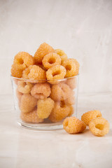yellow raspberry on a marble light background