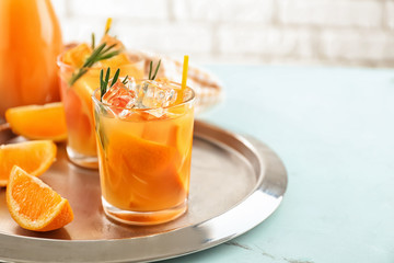 Glasses of tasty orange cocktail on tray