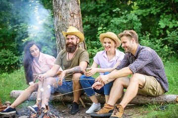 Hike barbecue. Friends enjoy weekend barbecue in forest. Best friends spend leisure weekend hike barbecue forest nature background. Company friends picnic or barbecue roasting food near bonfire