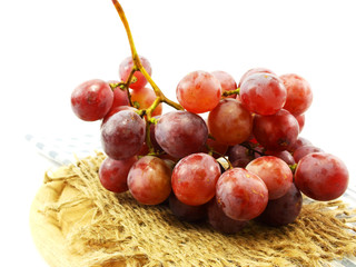red grape and red apples on tablecloth
