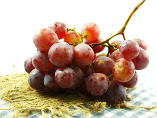 red grape and red apples on tablecloth