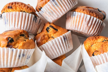 Tasty blueberry muffins on table, closeup