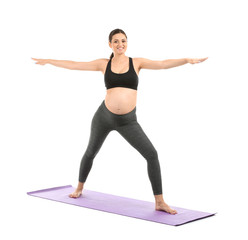 Fototapeta premium Young pregnant woman practicing yoga on white background