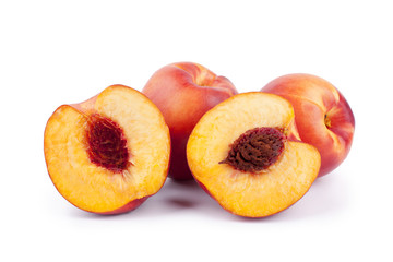 Peaches whole and halves with a stone inside on a white background isolated close up