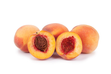 Velvet peaches whole and halves with stone on a white background isolated close up