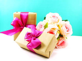 wrapped vintage gift box with pink ribbon bow and rose flower