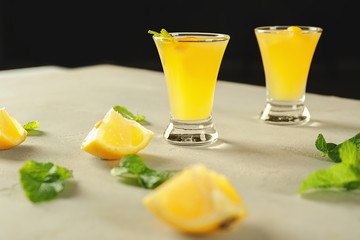 Glasses of fresh lemon cocktail on light table