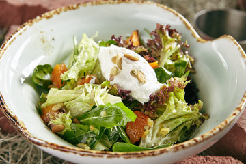 Homemade Rustic Salad with Baked Pumpkin and Cheese Mousse on Hay Background