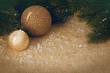 golden christmas bauble with branch and snow