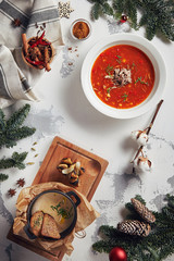 Obraz na płótnie Canvas Beautiful New Year Background with Mushroom and Tomato Soups Top View