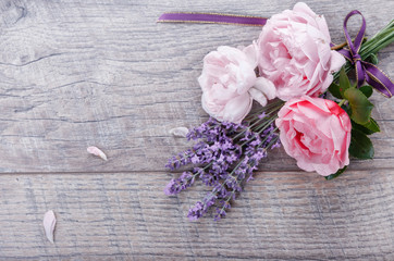 Fototapeta na wymiar Festive flower English roses composition with ribbon, lavender on wooden background, rustic style. Overhead top view, flat lay. Copy space. Birthday, Mother's, Valentines, Women's, Wedding Day concept
