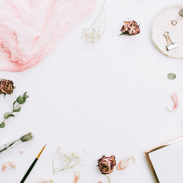 Frame with empty space, photo frame, pink blanket, eucalyptus branches and rose flowers on white background. Flat lay, top view still life artist blog hero header. Wedding concept.
