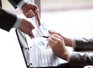 close up.colleagues are discussing financial data. development concept.