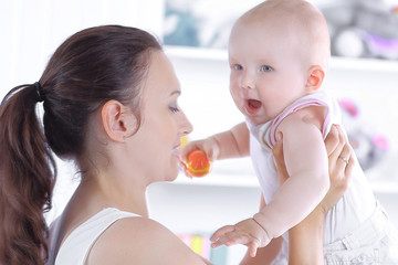 mother playing with baby from a comfortable apartment