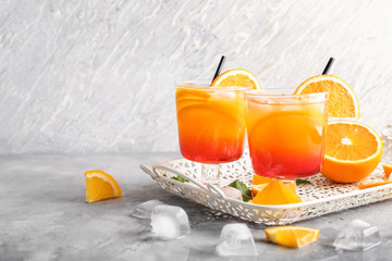 Fresh summer cocktail in glasses on grey table