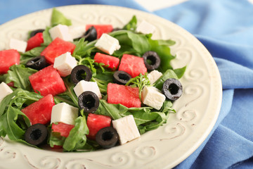 Tasty salad with watermelon, feta and olives on plate, closeup