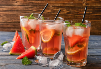 Glasses of tasty cold watermelon lemonade on wooden table