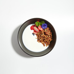Granola or Muesli in Black Restaurant Bowl Isolated