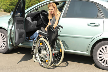 Handicapped woman getting out of her car