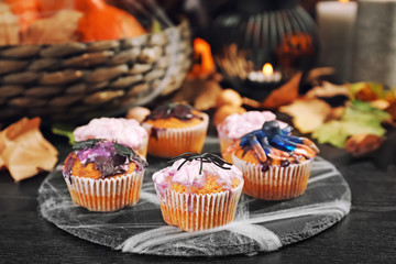Creative cupcakes prepared for Halloween party on slate plate