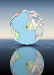 Fototapeta premium Senegal on globe with flags above water surface