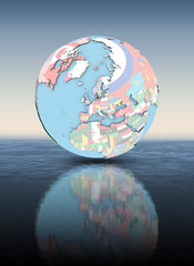 Denmark on globe with flags above water surface