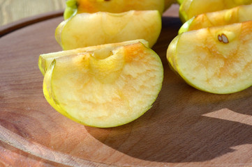 Sliced apples for cooking on a wooden tray