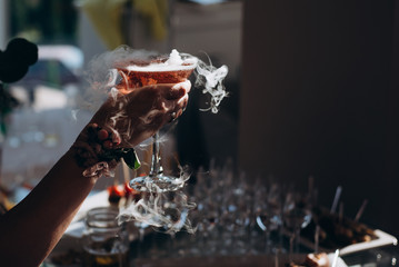  Hands holding the glasses of champagne and wine making a toast.
