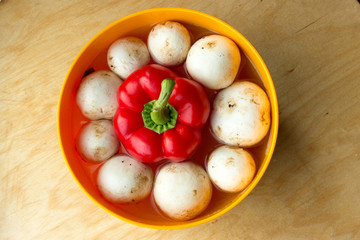 the mushrooms around the pepper in water in a bowl