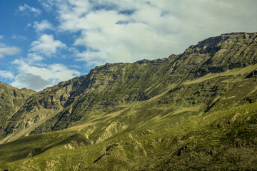 mountain green slopes snow-white clouds