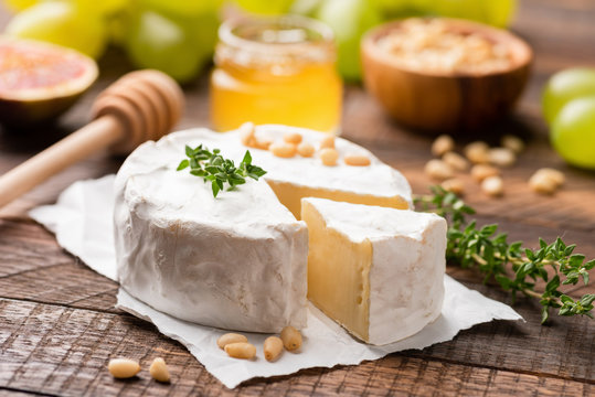 Camembert or Brie cheese served with honey, pine nuts, grapes and figs.