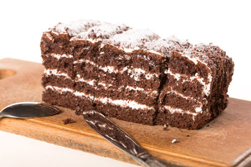 Few slices of chocolate cake on wooden desk